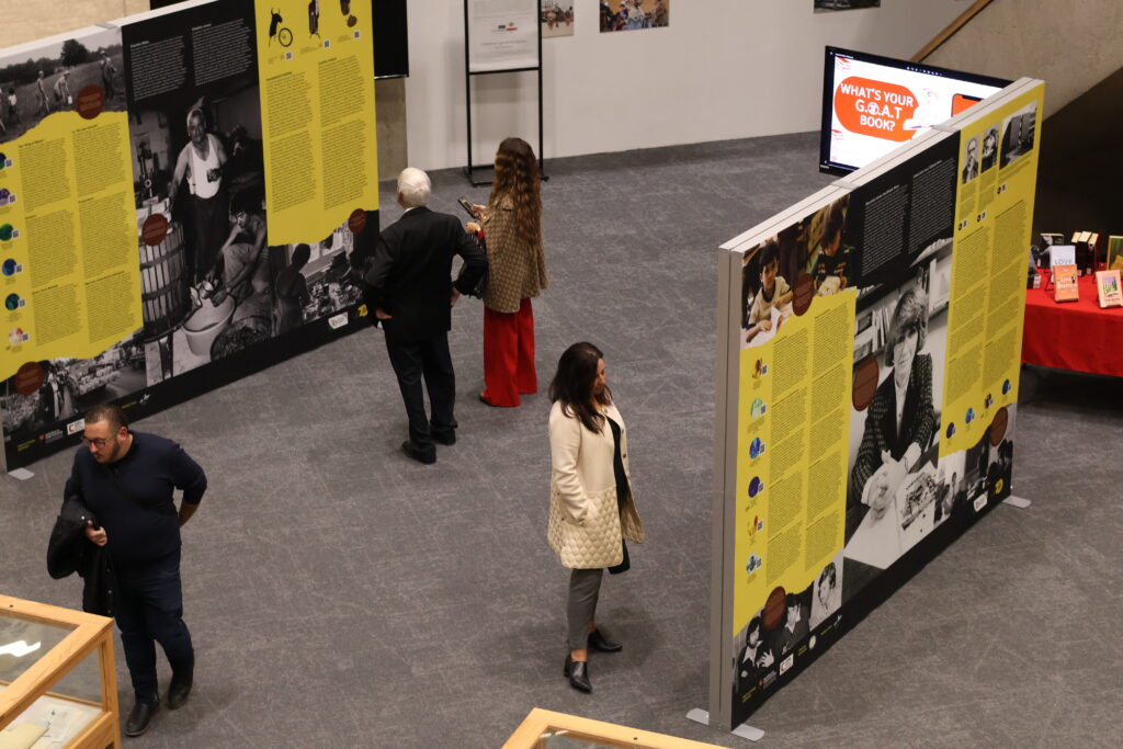 People viewing the Movimento Perpetuo exhibit in the Scott Library atrium. 